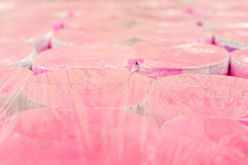 pink toilet paper in transparent plastic packaging