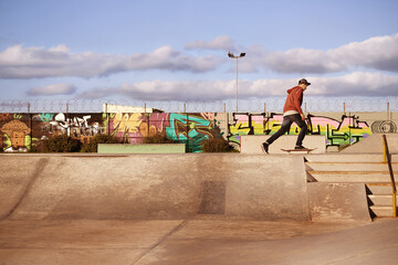 Man, skateboard and ramp in skatepark for summer, skate and recreation for fun and active for game or holiday. Young person and performing, trick and sports for wheel, move and action on mockup © Mariusz S/peopleimages.com