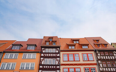 Fototapeta na wymiar spring trip to Europe. Travel and German sightseeing locations. scenic view to facade of old historic houses somewhere in Erfurt city, Traditional half-timbered houses makes cozy and fairy tail mood