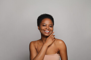 Smiling wellness model woman with dark shiny skin and cute smile close-up portrait. - 763179103
