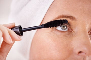 Makeup, mascara and closeup of woman with brush in studio for beauty, cosmetics or application....