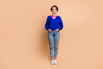 Fototapeta na wymiar Full size photo of attractive young woman hands pockets shopping promo wear trendy blue clothes isolated on beige color background