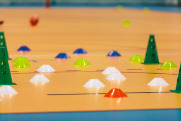 Sports Training Equipment on Indoor Sports Field. Training Cones and Markers