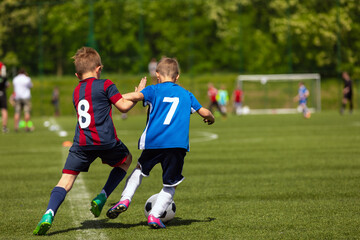 Young Players in Sports Duel. Two School Boys Playing a Competitive Soccer Football Game.Kids...
