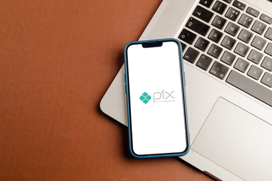 Pix logo on smartphone screen on white background. Pix is the new instant payment system from the Central Bank of Brazil.