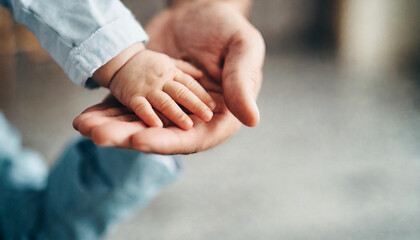 baby's hand grasping adult's hand, symbolizing trust and connection against clean background 