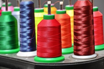 close up view of colorful spools of thread for fabrics.
