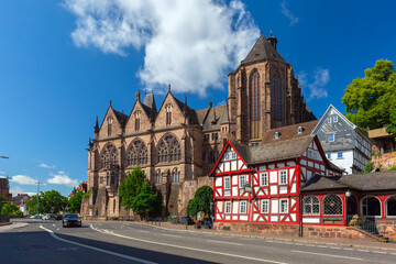 Medieval street with traditional half-timbered houses and University Church, Marburg an der Lahn, Hesse, Germany - obrazy, fototapety, plakaty