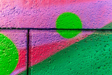 Colorful beautiful background of urban spray drawing graffiti on city wall. Bright vivid pattern of  modern art for wallpaper and design.