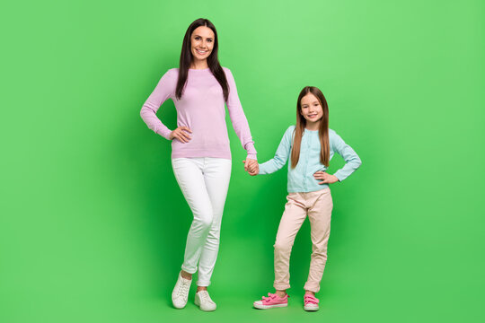 Fototapeta Full length photo of sweet cute mommy small girl wear casual outfits walking holding arms isolated green color background