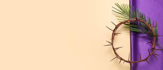 Crown of thorns with palm leaf and purple fabric on beige background. Good Friday concept - obrazy, fototapety, plakaty