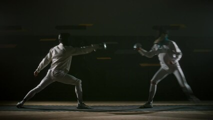 Side full footage of fencers moving around fencing piste thrusting, clashing and demonstrating swordsmanship during duel