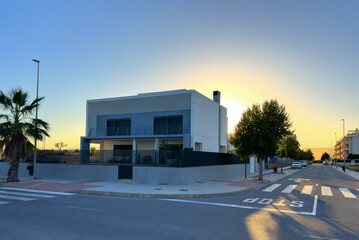 Villa on sunset. Prefabricated home on street in city. Construction of Modular house. Spain Villa...