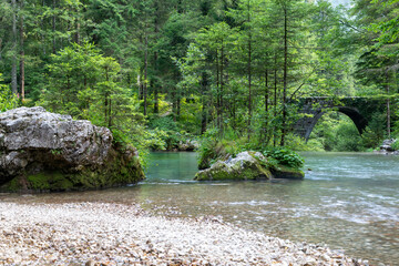 The spring of the forest river with magic old stone bridge, the Kamnik Bistrica, Slovenia.  - 763204393