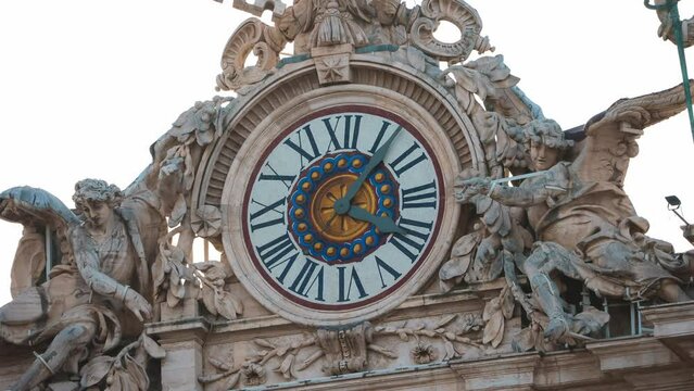 Close up view of the clock on top of the Vatican city. Timelapse of the clock arrow moving in time. Clock on facade of Saint Peter basilica in Vatican. Rome, Italy