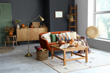 Interior of living room with pumpkins and food on table
