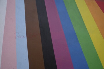 LGBTIQ+ flags colors on a wall