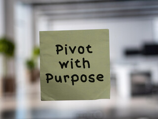 Post note on glass with 'Pivot with Purpose'.