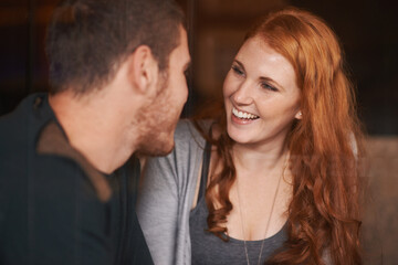 Obraz premium Happy couple, bonding and laughing with funny joke at cafe for romance, support or romance at indoor restaurant. Man and woman with smile in happiness for social, conversation or friendly discussion