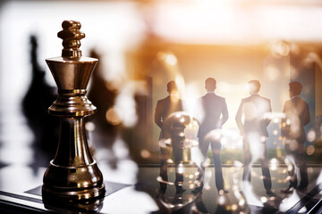 double exposure of chess piece on chess board game with silhouette business team and strategy, business success concept, business competition planning teamwork strategic concept.	 - 763235163
