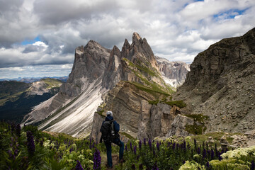 Fototapeta premium Mountain view with climber, Seceda mountain, Dolomites, Italy.
