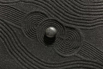 Fototapeten Stone on dark sand with lines in Japanese rock garden, top view. Zen concept © Pixel-Shot
