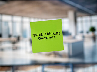 Post note on glass with 'Quick-Thinking Quotient'.