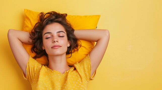 a young woman sleeping on pillow isolated on pastel pink colored background Sleep deeply peacefully rest. Top above high angle view photo portrait of satisfied .senior wear yellow shirt
