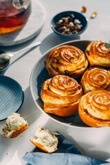 homemade pastries on a plate, light background, no people, close-up, cozy atmosphere, sunlight