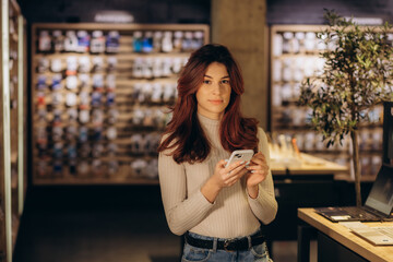 beautiful young woman in an electronics store