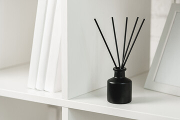 Elegant Black Reed Diffuser on White Shelf in Minimalist Home Decor Setting