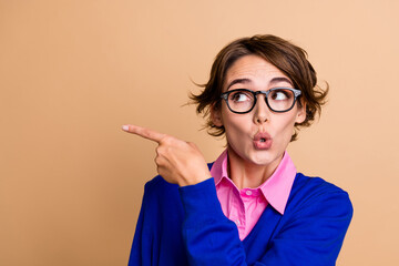 Photo portrait of pretty young girl point amazed empty space plump lips wear trendy blue outfit...