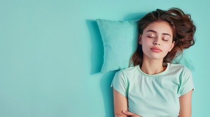 a young woman sleeping on pillow isolated on pastel blue colored background Sleep deeply peacefully...