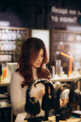 Buyer trying on headphones in audio store