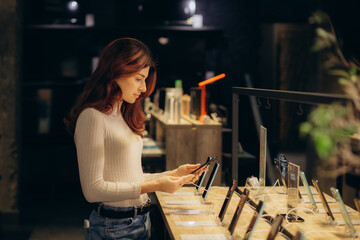 a woman buys a phone in an electronics store