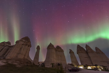 Cappadocia region fairy chimneys with northern lights and sunset clouds and colors