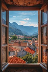 A view through an open window, revealing a scenic European village with cozy small houses and a stunning mountain backdrop - 763246111