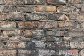 Close-up of an old, multi-colored brick wall showing texture, weathering, and patterns