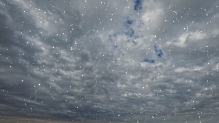 pretty fall of snow on clouds on sky bg - photo of nature