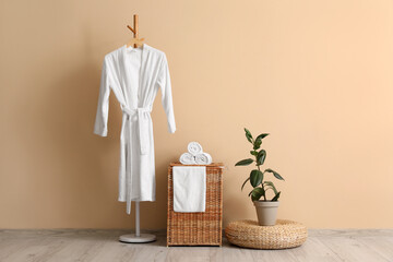 Interior of room with laundry basket, bathrobe and pouf