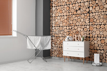 Interior of room with laundry basket, commode and dryer