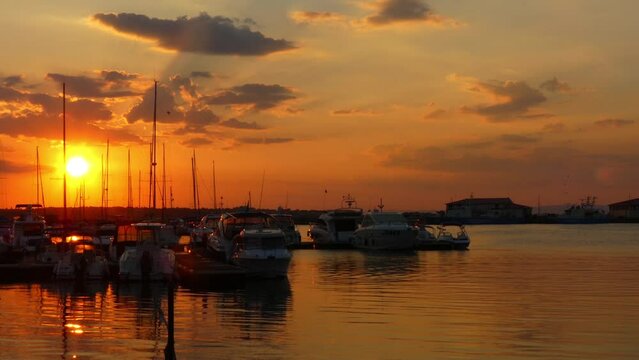 Yachts and ships against backdrop of sunset