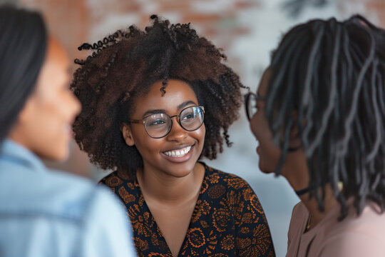 Group of African American women having a conversation in the office - Powered by Adobe