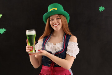 Young woman with beer on dark background. St. Patrick's Day celebration