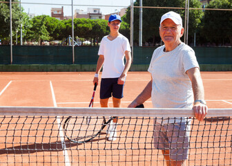 Senior man posing on tennis court