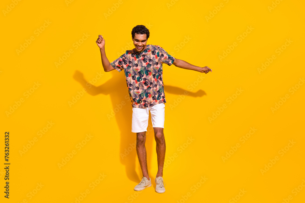 Wall mural Full body length photo of carefree youngster positive man enjoying the party rhythm have fun isolated over yellow color background - Wall murals