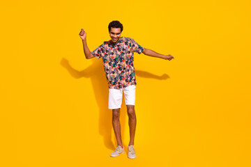 Fototapeta na wymiar Full body length photo of carefree youngster positive man enjoying the party rhythm have fun isolated over yellow color background