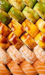 Set of colorful rolls with shrimp, salmon, avocado, cheese, top view.