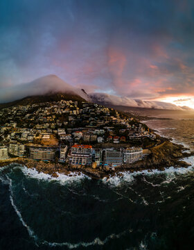 Panoramic aerial view of Bantry Bay and low cloud over Lion&rsquo;s Head Mountain with Table Mountain in background at sunset, Bantry Bay, Cape Town, South Africa.