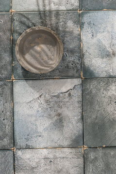 Small empty bowl on square tiles
